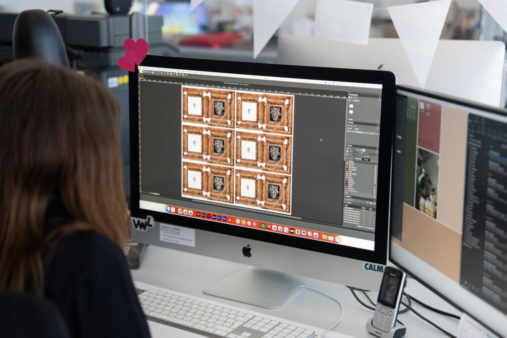 WEROCA employee processes the layout of printed cardboard packaging in prepress – precise print data preparation for high-quality packaging solutions at WEROCA Cartons in Bielefeld